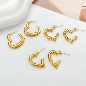 Three pairs of stylish gold heart earrings featuring ribbed, wavy, and smooth textures