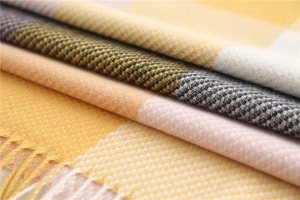 Close-up of fringe details and soft plaid weave texture on this cashmere-like scarf