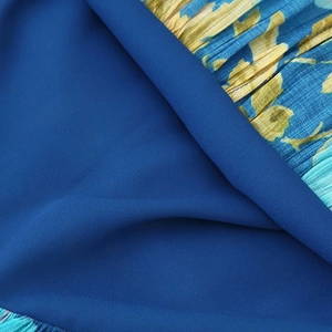 Floral print pleated chiffon dress featuring ruffled tiered layers and a deep blue fabric
