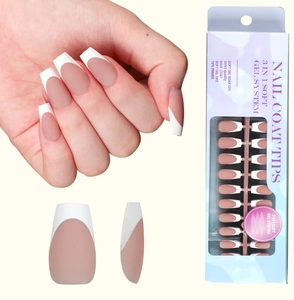 Close-up of soft gel French tip nails featuring classic nude pink base and white tips