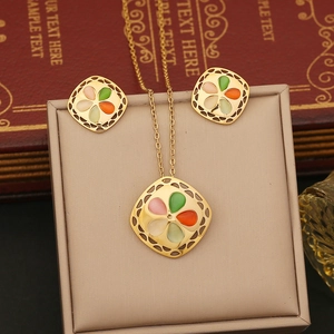 Vintage gold necklace and earring set with square hollow design and cat eye stones