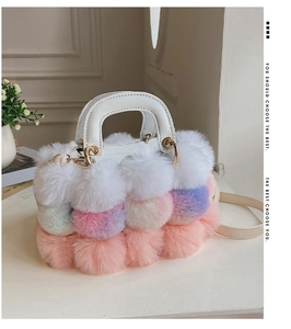 Detail of multi-colored faux fur handbag with leather handle and golden hardware