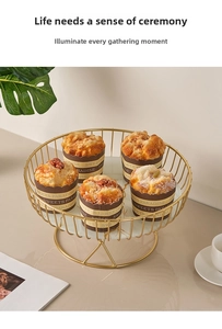 Close-up of golden metal dessert stand with marble base holding five cupcakes