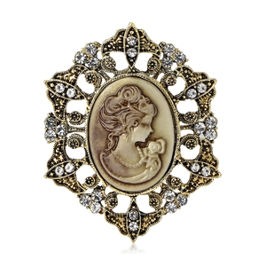 Vintage gold alloy cameo brooch with rhinestone crystals and feminine silhouette
