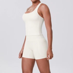 Detail of high-waist yoga shorts with side pocket and racerback sports bra in cream