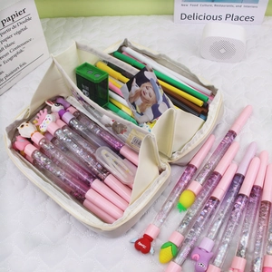 Macro detail of large capacity cream canvas pencil case with dual storage and stationery