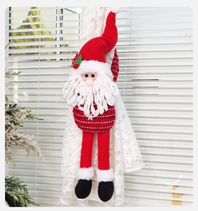 Close-up of Santa Claus curtain buckle with knitted texture on lace curtains