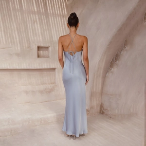 Detail of cross tie back design on a light blue satin evening dress with floor length hem