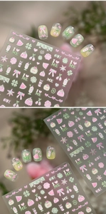 Detailed macro view of 3D embossed nail stickers with sweet bow and fruit patterns