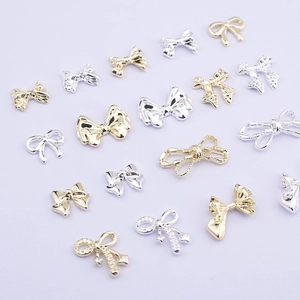 Golden and silver metal bow-knot nail art charms for elegant DIY manicure decoration