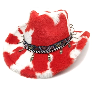 Detail of red and white cow print plush cowboy hat with ethnic woven band and pendants