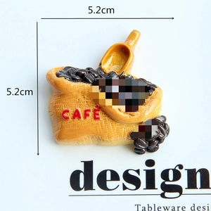 Detailed 5.2cm resin coffee bean sack magnet with CAFE text and a small yellow scoop