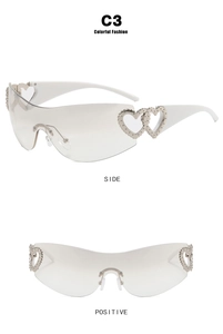 Detail of white Y2K shield sunglasses with metallic heart accents on temple joints