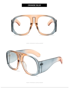 Detail of oversized orange and blue gradient sunglasses with wide temples on white background