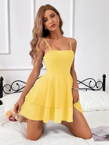 Front view of bright yellow mini dress with spaghetti straps and double-layer ruffled hem