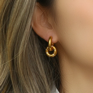 Detail of model wearing 18K gold plated hoop earrings with micro-set sparkling crystals