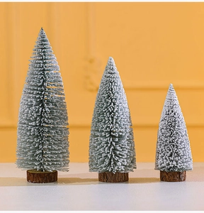 Three sizes of mini flocked Christmas trees with faux snow effect and wooden bases