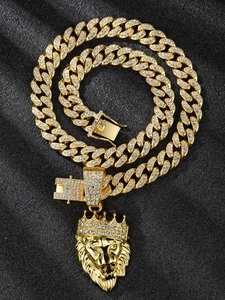 Detailed close-up of golden lion head pendant with diamonds on iced-out Cuban link chain