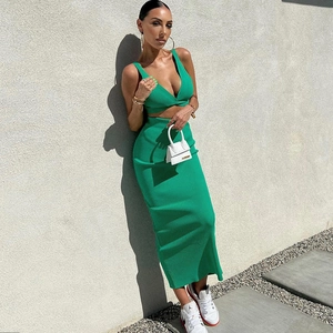 Slim fit emerald green knit two-piece set featuring a deep V-neck crop top and midi skirt