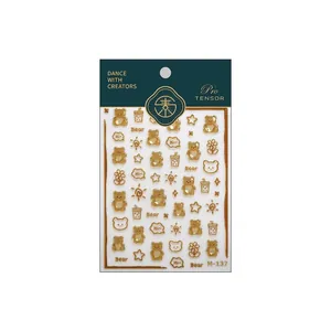 Bronzing nail stickers with brown cartoon bear patterns and gold glitter accents