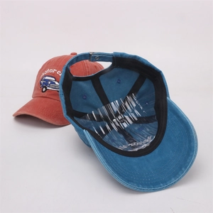 Detail showing vintage washed cotton fabric and classic car embroidery on baseball caps