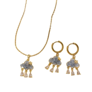 Golden necklace and earrings set with cloud blue crystals and zircon star pendant drops