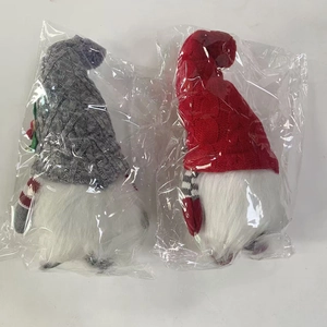 Detail of plush Christmas gnomes featuring knitted hats and long white beards in packaging
