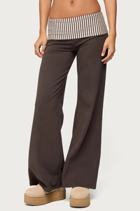 Detail of dark grey wide leg trousers showing soft fabric texture and relaxed loose fit