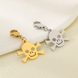 Close-up of gold and silver skull crossbones pendants with metal lobster clasps