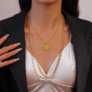 Layered 18K gold plated stainless steel necklace with sun coin pendant and pearl accents
