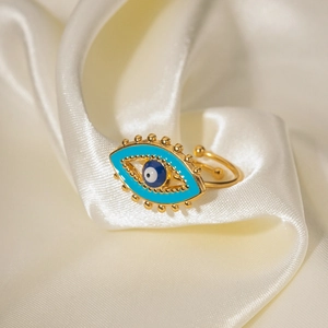 18K gold plated evil eye ring with blue enamel and adjustable band on white silk background