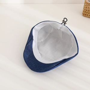 Detail of denim beret interior with white lining and adjustable black elastic drawstring