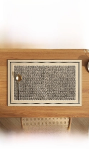 Detail of waterproof beige faux linen leather placemat with elegant dot edge texture