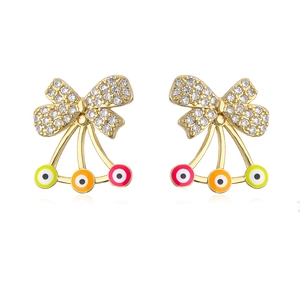 Detail of 18K gold bow stud earrings with zircon inlay and colorful evil eye drops