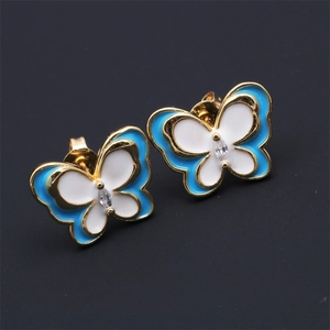 Macro shot of blue and white enamel butterfly earrings with marquise cubic zirconia