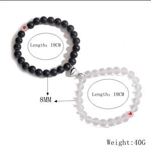 Detail view of magnetic heart clasp on couple bracelets with 8mm matte beads