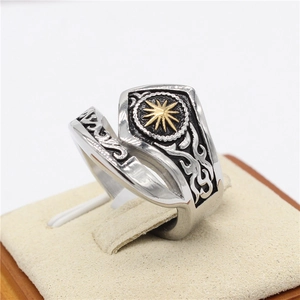 Macro detail of vintage sunburst pattern on two-tone stainless steel punk ring
