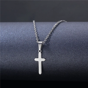 Polished silver stainless steel cross pendant necklace hanging on a display stand