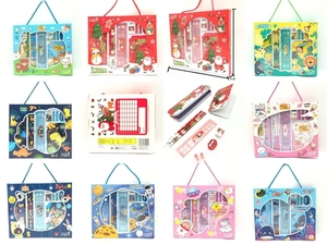 Detail view of children's stationery set including tin pencil case and notebooks in gift box