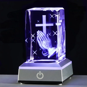 Detailed 3D laser engraved praying hands and cross within a crystal with LED base