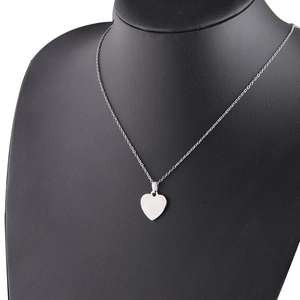 Polished silver heart pendant necklace displayed on a black neck bust for women