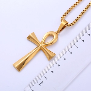 Golden Ankh cross necklace in stainless steel shown with a ruler for size measurement