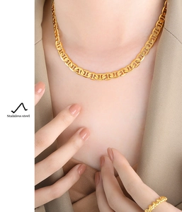Detail of 18k gold plated stainless steel pig nose chain necklace on model
