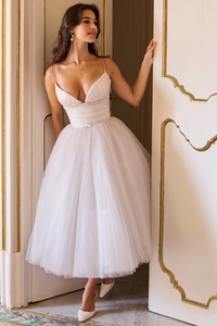 Detailed view of white tulle fabric texture and layered mesh hem on backless dress