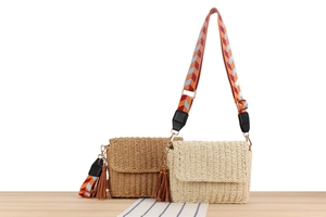 Close-up of handwoven beach crossbody bag with colorful strap and leather tassel detail