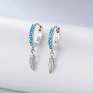 Detailed close-up of S925 silver feather earrings with blue turquoise gemstone inlay