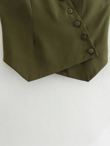 Detail of army green asymmetric vest showing side button closure and woven fabric texture