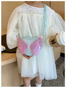 Detail showing blue sequin crossbody bag with pink laser wings and adjustable shoulder strap
