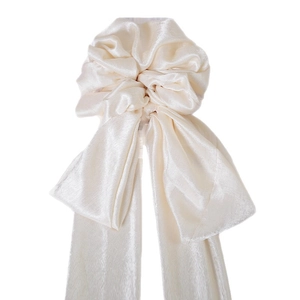 Elegant cream satin bow scrunchie with long ribbons and smooth glossy texture