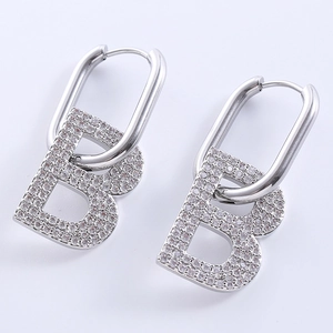 Detailed view of silver B-letter earrings featuring sparkling crystal rhinestones set in metal